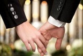 13712561-religion-death-and-dolor--couple-at-funeral-holding-hands-consoling-each-other-in-view-of-the-loss[1]